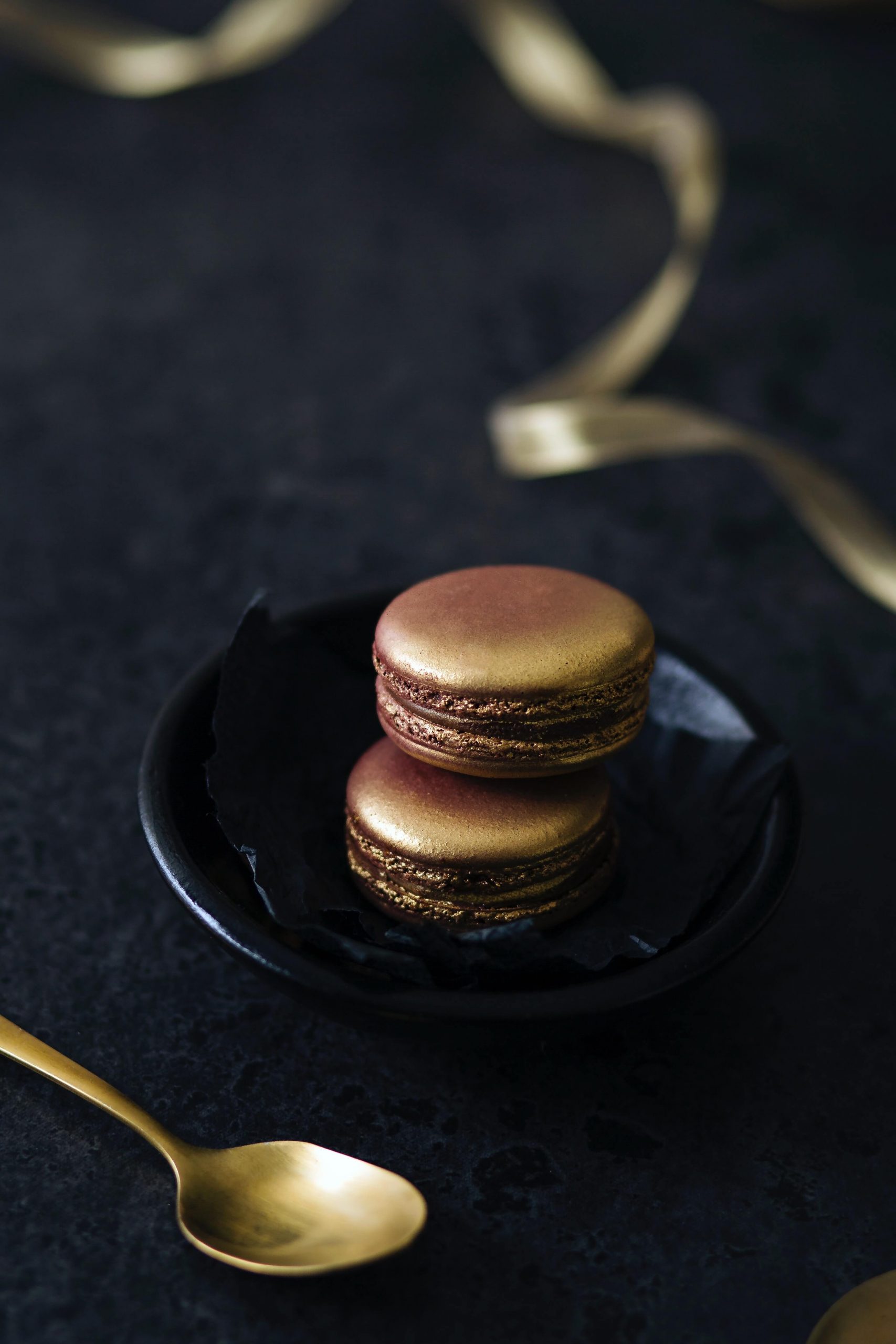 Gold Macarons on Tea Plate with Gold Spoon